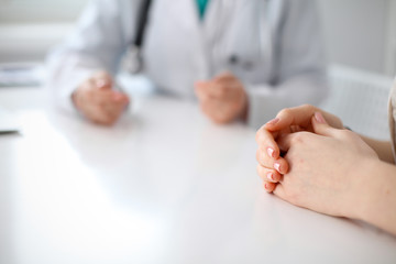 Doctor and patient are discussing something, just hands at the table