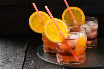 Aperol cocktail with orange slices and ice