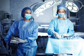 Caucasian surgeons preparing operating room
