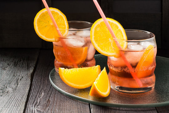 Aperol cocktail with orange slices and ice