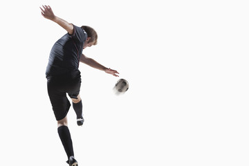 Fototapeta na wymiar Athlete kicking soccer ball