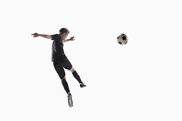 Athlete kicking soccer ball