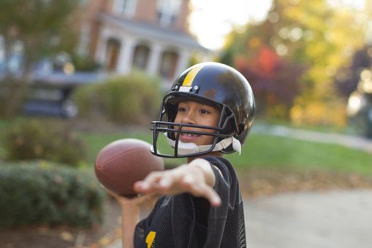 A boy playing football outdoors