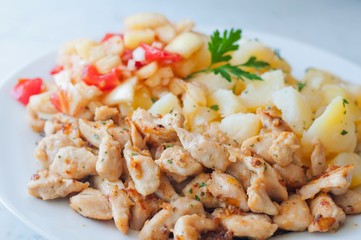 Chicken curry nuggets with potato and vegetables on plate