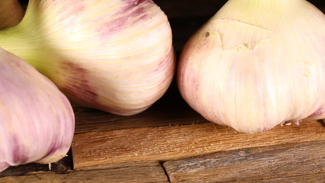 Organic garlic on wooden background. Macro shot.