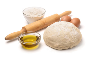 Dough with flour, olive oil, eggs and rolling pin