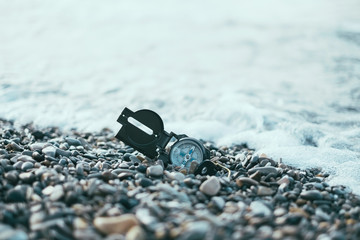 Compass near the sea waves