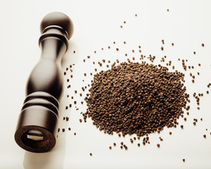pepper mill and peppercorns heap, white background