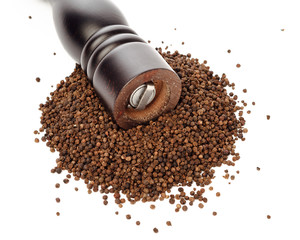 pepper mill on peppercorns heap, isolated on white