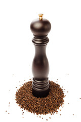 pepper mill on peppercorns heap, isolated on white