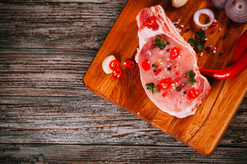 Organic raw pork meat on bone on chopping board