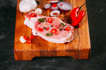 Organic raw pork meat on bone on chopping board