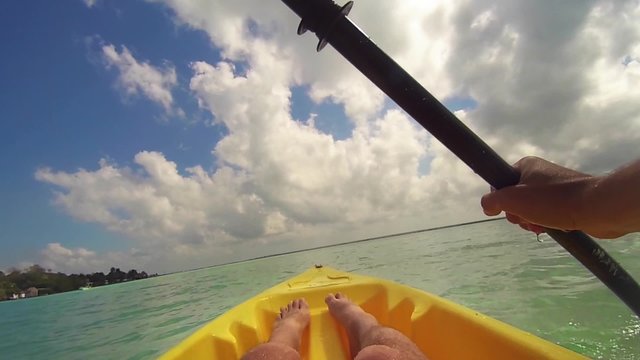 Front perspective of Man Kayaking on Bacalar lagoon. slow motion