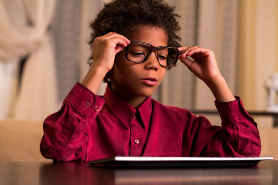 Sleepy Black Kid At Keyboard. 