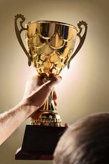 Fototapeta na wymiar Athlete holding trophy cup