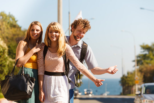People friends hitchhiking on summer vacation.