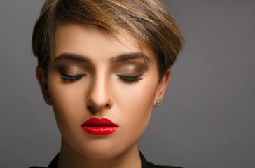Glamour portrait of a beautiful lady with short hair and proffessional make up.