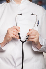 Doctor's hands with stethoscope on a blurred background