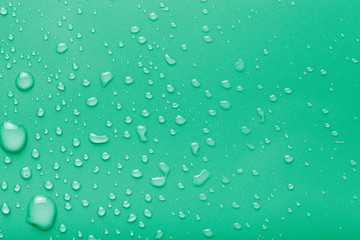 Dops of water on a color background. Green. Toned