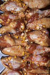 Marinated chicken wings on a black pan