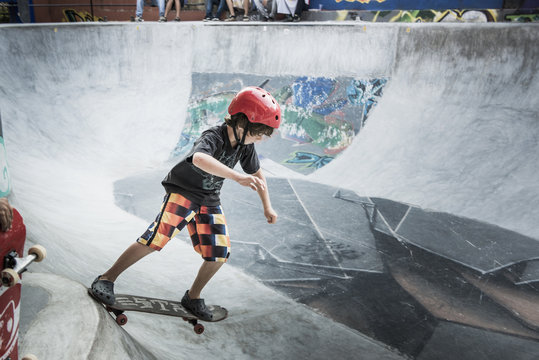 Caucasian boy riding skateboard in skate park - Powered by Adobe
