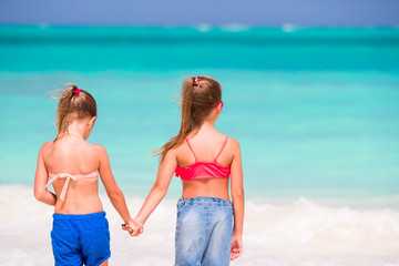 Adorable little girls at beach during summer vacation