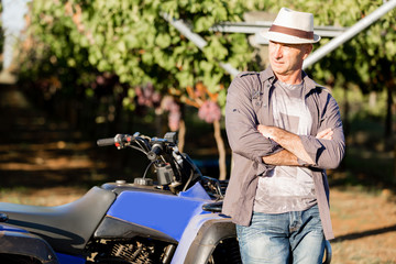 Man standing next to truck in vineyard