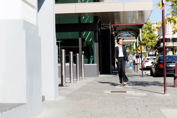 Portrait of business woman walking outdoor