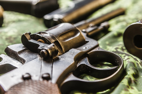 Detail of vintage generic 9mm pistol on pixel camouflage