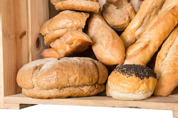 Bread in wooden box isolated on white background with clipping p