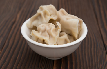 bowl full of dumpling on wooden background