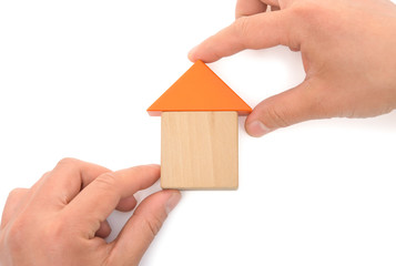 hands making up a house on white with clipping path