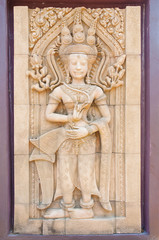 Fototapeta na wymiar Carving of Hindu god Vishnu standing with
