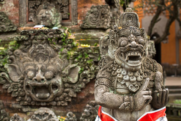 Traditional demon statue carved in stone on Bali, Indonesia.