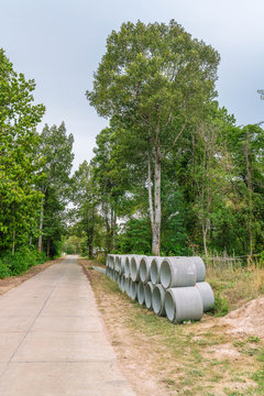 Concrete drainage pipes for industrial building construction stacked at roadside