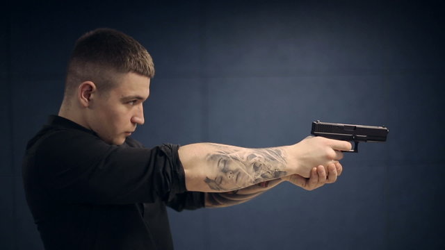 Firearms practice: Man is shooting from laser gun