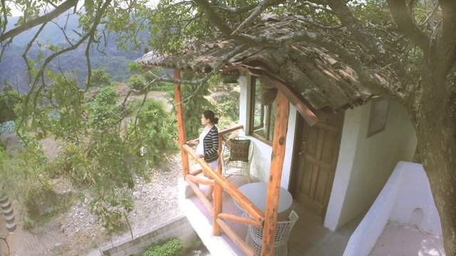 Woman seated on a beautiful terrace with amazing view of planted land in Guatemala. 4k
