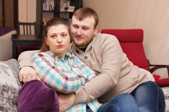 Husband hugs and comforts his wife