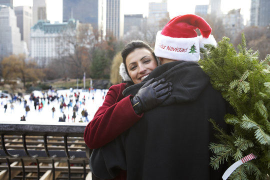 Couple hugging on city street