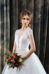 attractive bride in wedding dress in studio