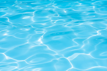 Fototapeta na wymiar Beautiful gentle wave with sun reflection in swimming pool 