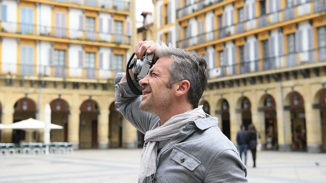 Man taking pictures on travel journey