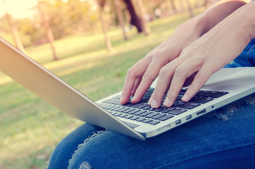 closeup women use laptop computer outdoor at sunset