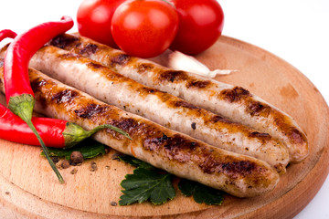 Grilled sausage with red hot pepper and tomatoes