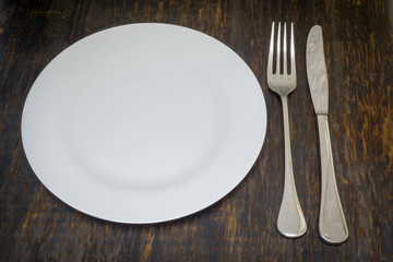 Table setting. Dinner plate, fork and knife
