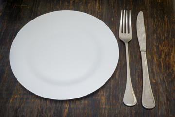 Table setting. Dinner plate, fork and knife
