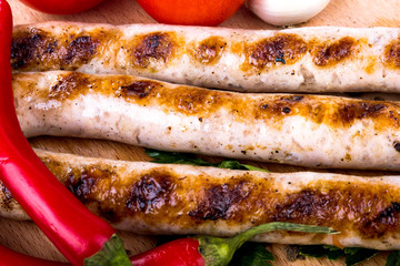 Grilled sausage with red hot pepper and tomatoes