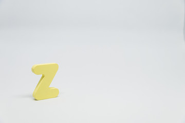 Yellow Wooden alphabet Z with white background