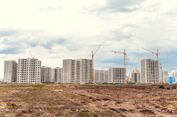 Multistorey building and big cranes