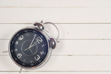 Vintage background with retro alarm clock on table